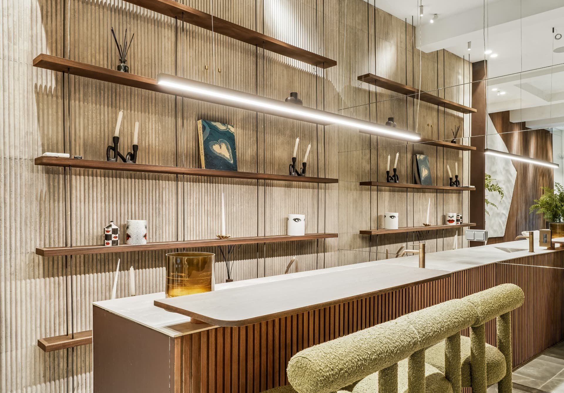 Bar à comptoir clair et façade à tasseaux de bois, avec chaises hautes en tissu bouclé